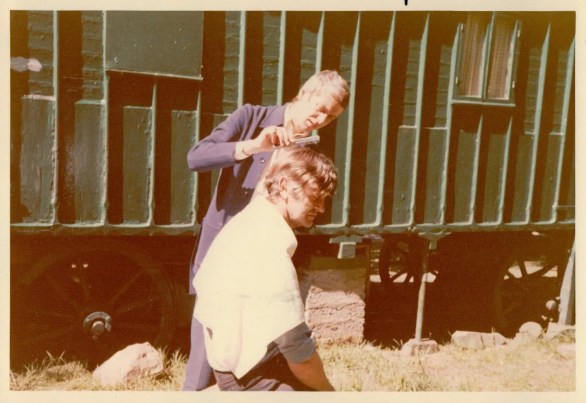 Ronnie Cogan cutting Martin Neville's hair