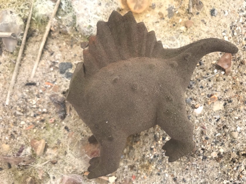 Rubbish - headless dinosaur found on a beach clean